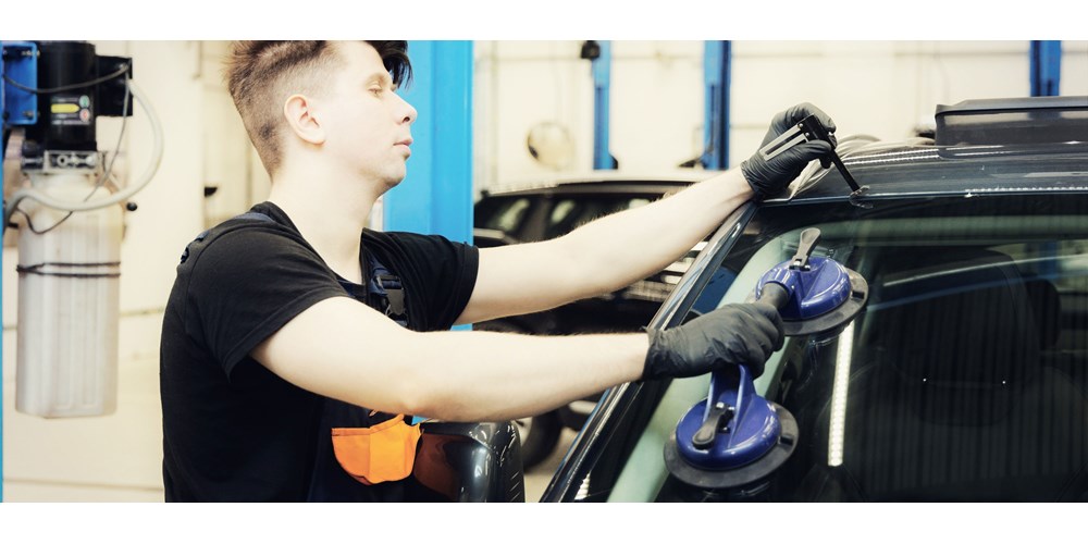 Mechanic repairs windscreen chip