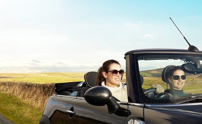 Two women in a car smiling