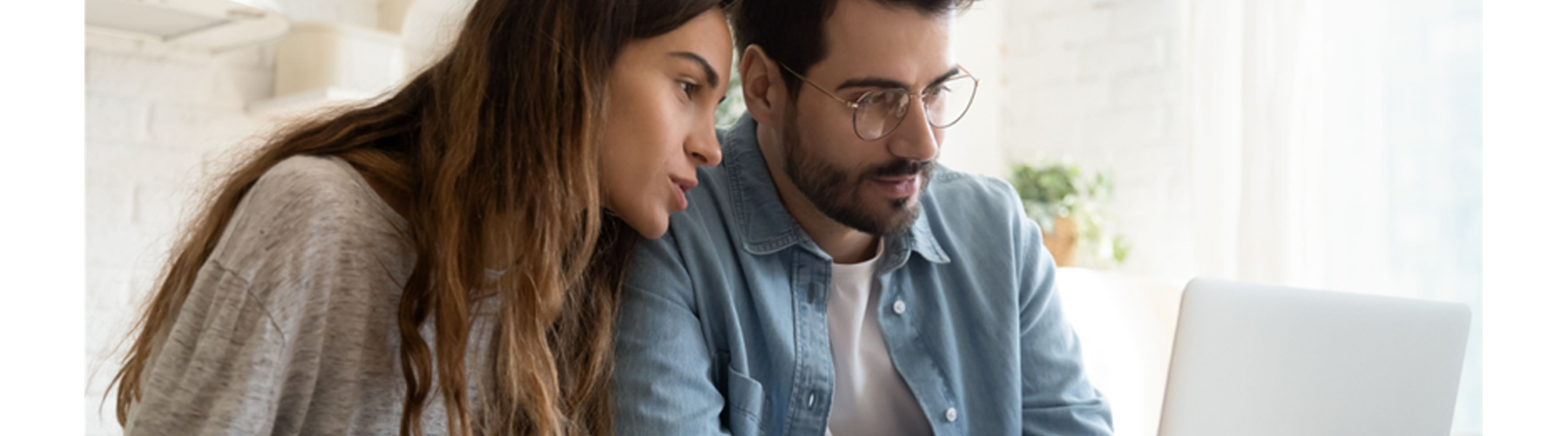 Couple using laptop at home